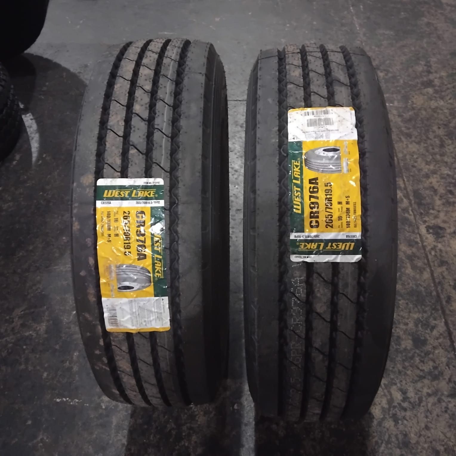Two new 265/70R19.5 tyres standing side by side
