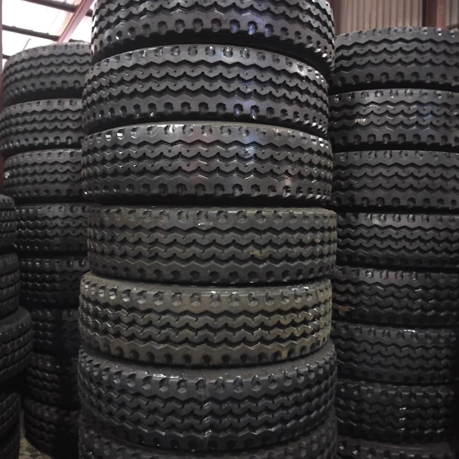 Stacks of 315/80R22.5 M103 stock retreads in the 3G Tyres warehouse