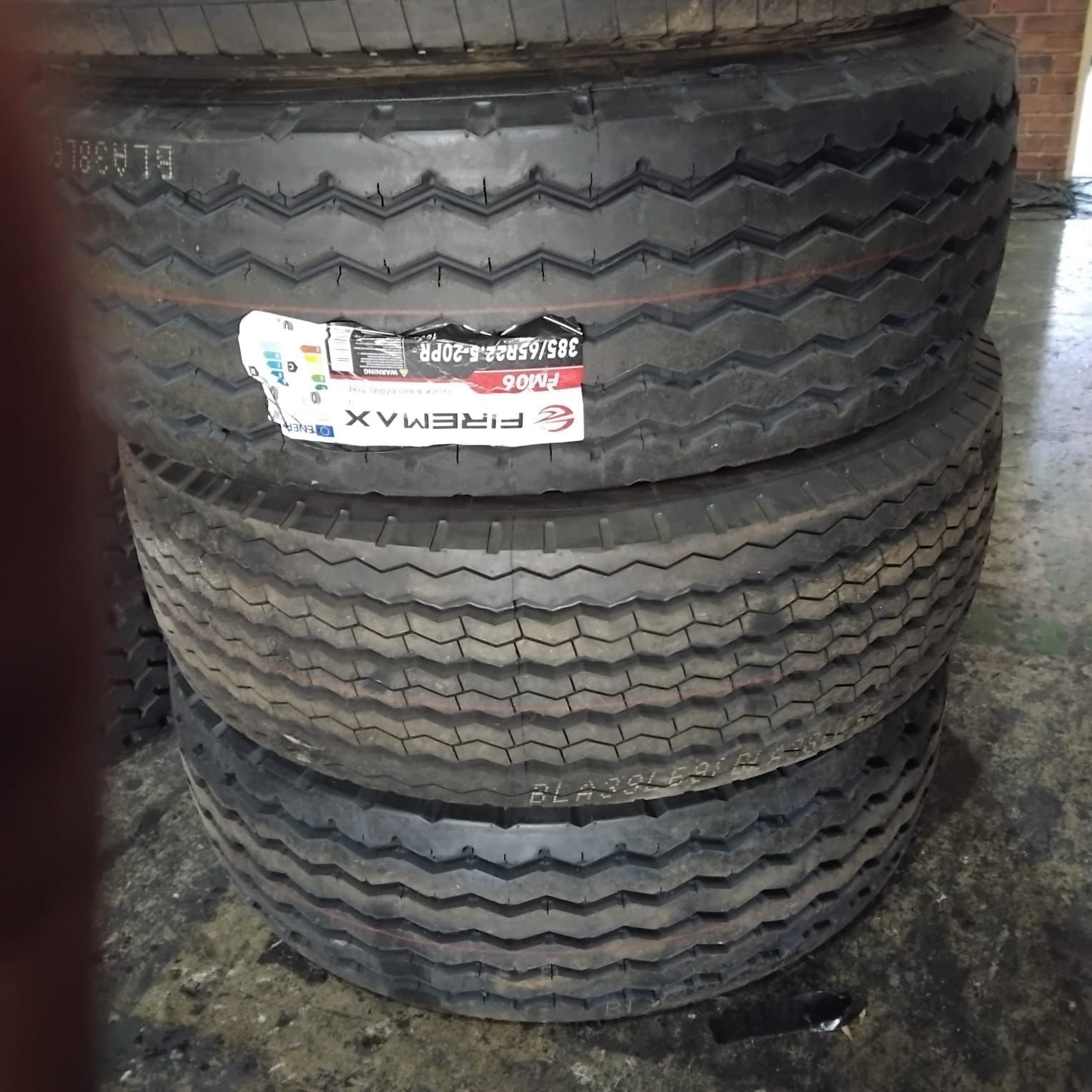 New Firemax 385/65R22.5 tyres stacked on the warehouse floor