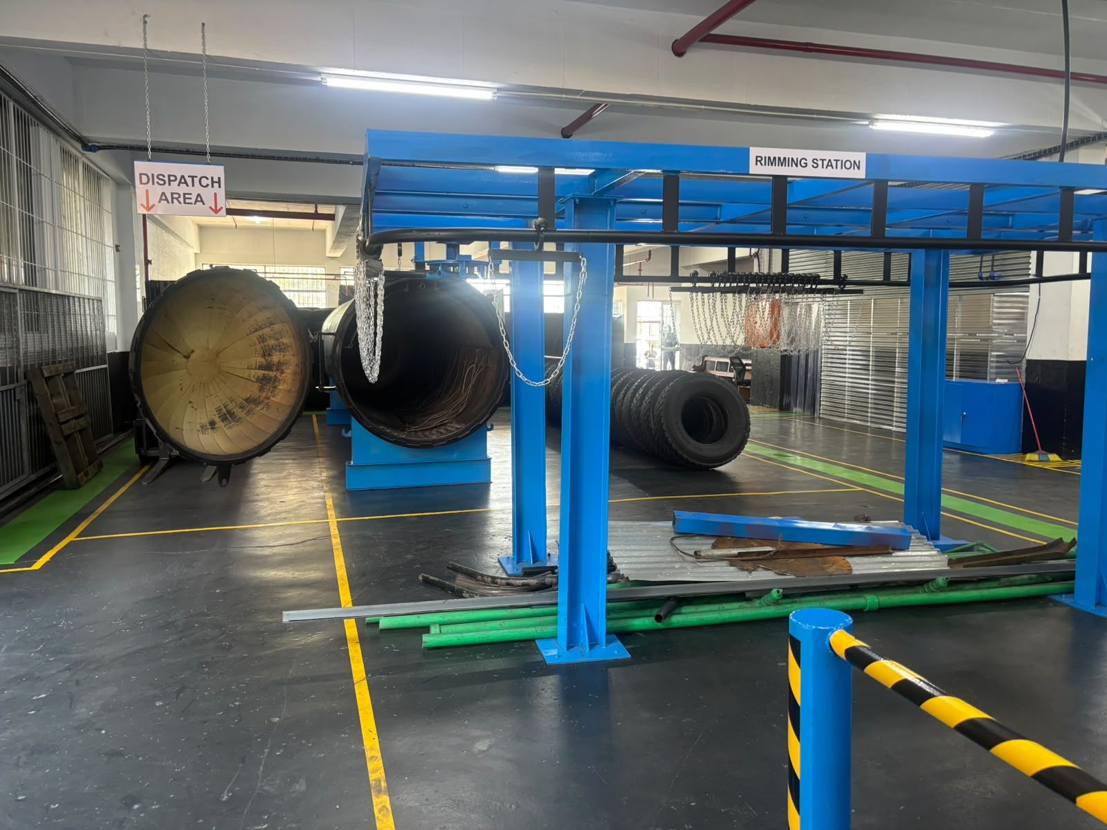 Rimming station and dispatch area inside the 3G Tyres retread plant, with safety-lined floors