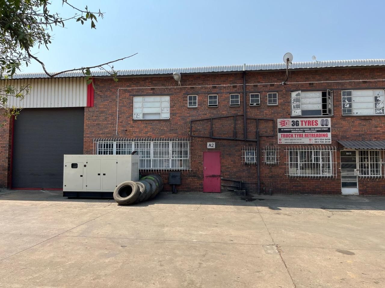 The 3G Tyres building at Robertville Mini Factories, with tyres and the roller door in front
