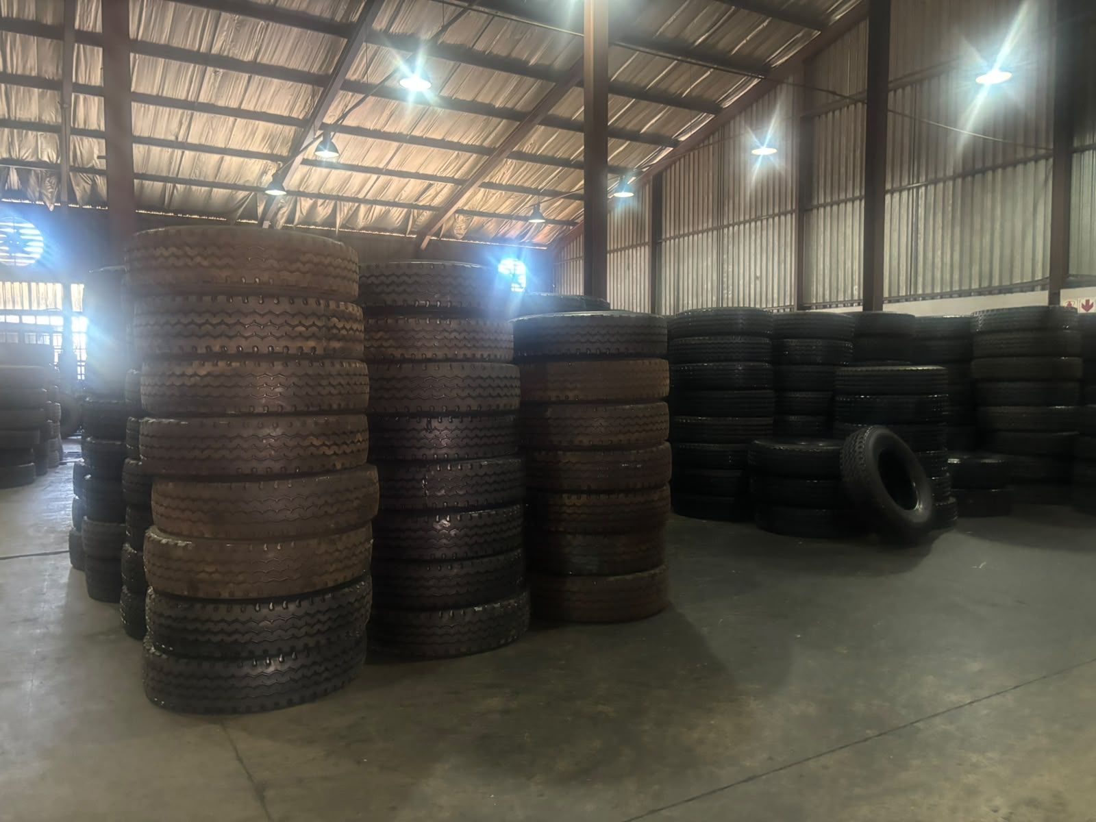 Stacks of new and retreaded truck tyres inside the 3G Tyres warehouse in Robertville